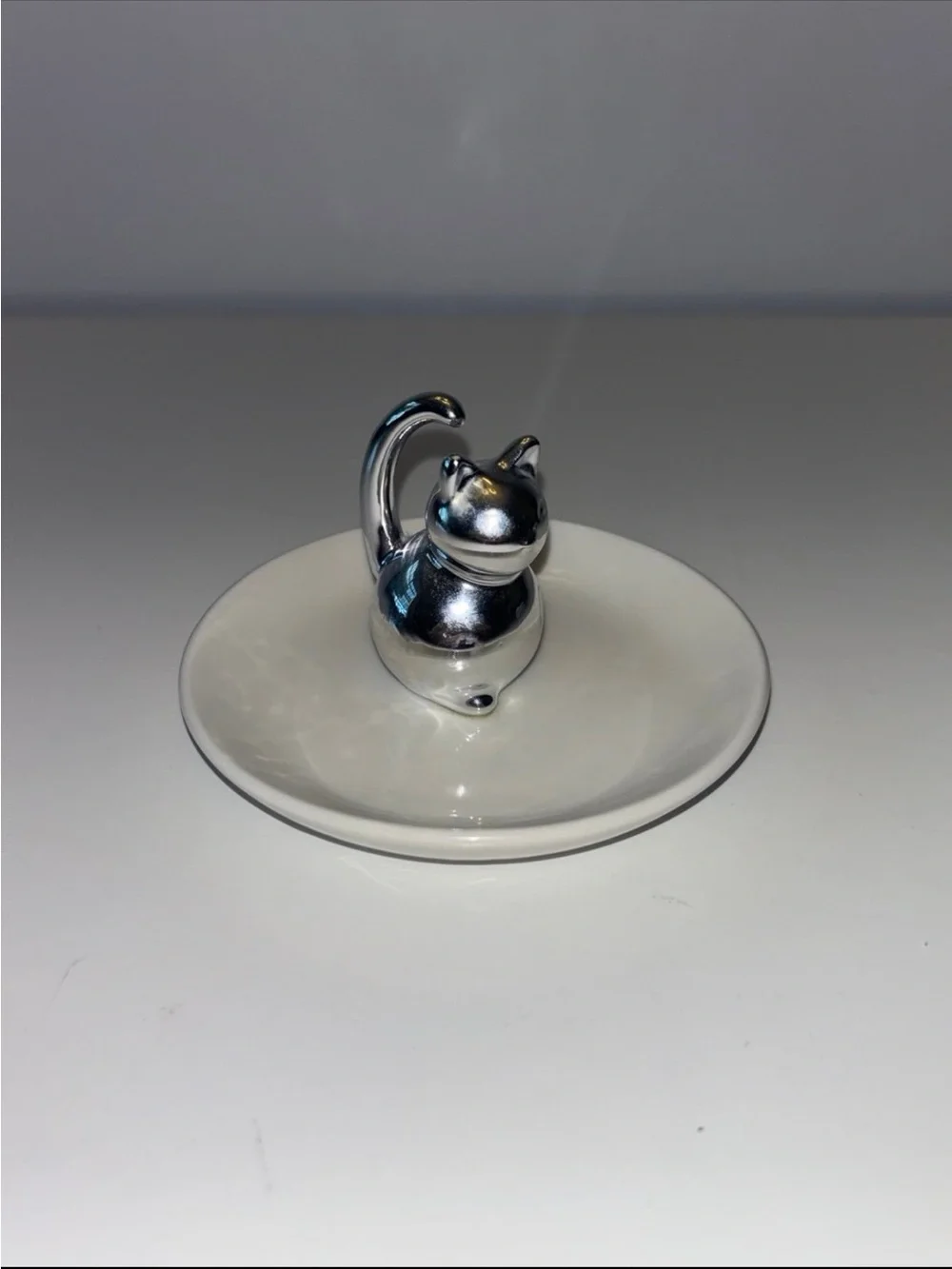 Silver Cat Ring Holder on White Ceramic Dish